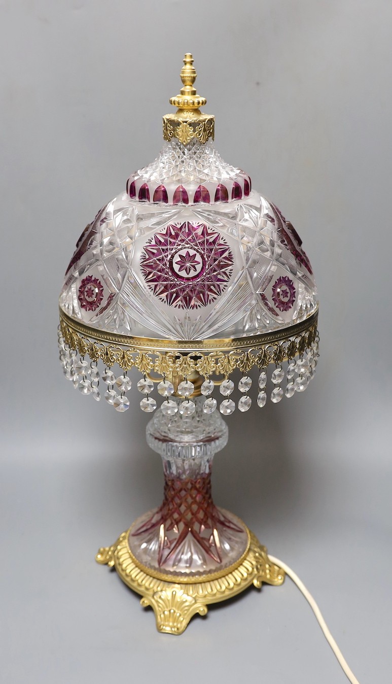 An amethyst flashed cut glass and ormolu table lamp, 58 cms high.